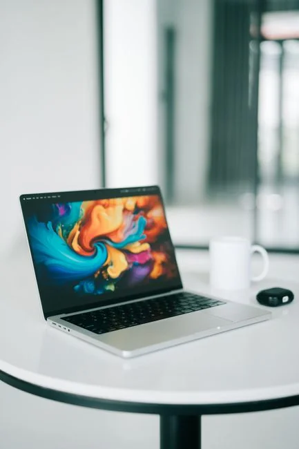 A close-up view of hands using a laptop indoors while browsing a shopping website.
